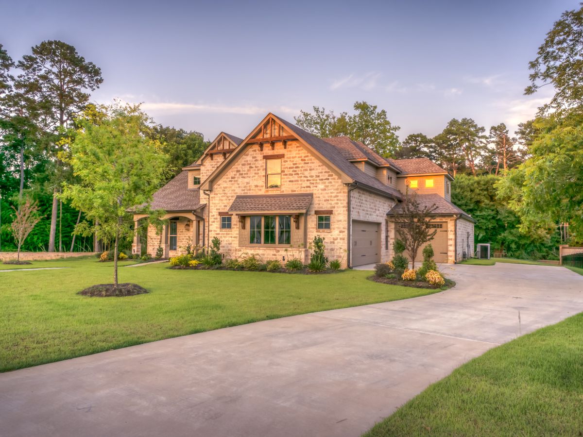Finished suburban home with dark architectural shingle roof